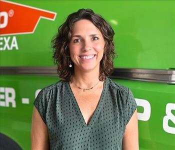 Woman standing in front of SERVPRO Fleet 