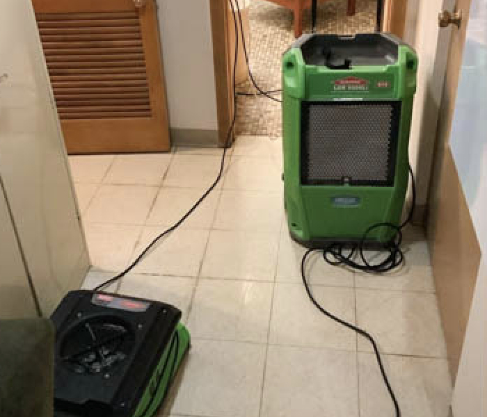 SERVPRO drying and water extraction equipment on hallway floor
